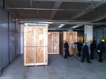 Crated equipment arriving and installation crew